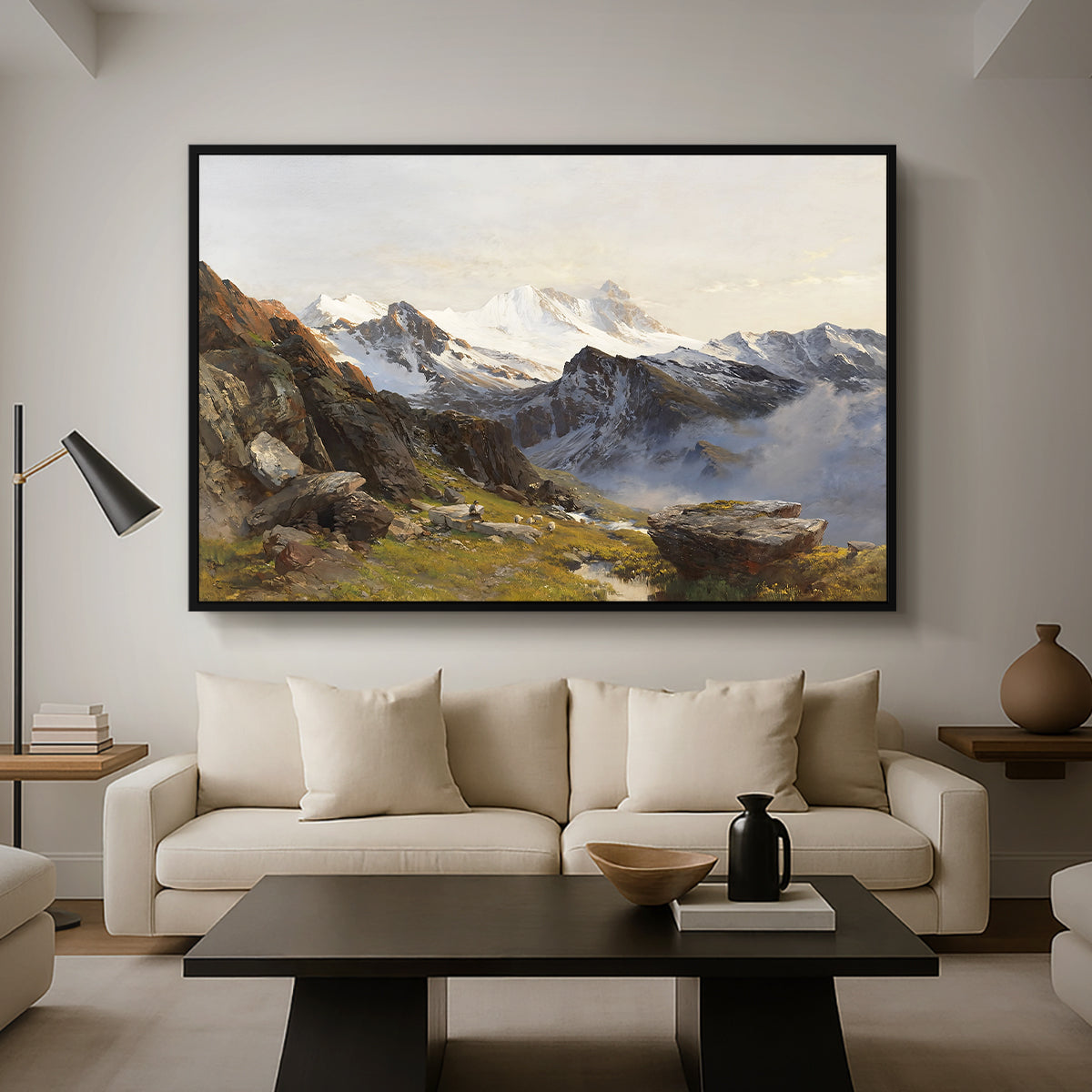The Großglockner from the Prager Hut, 1890 by Edward Theodore Compton as a black floater framed canvas featuring a view of Großglockner peak from alpine hut overlooking valley, displayed above a sofa in a modern living room.
