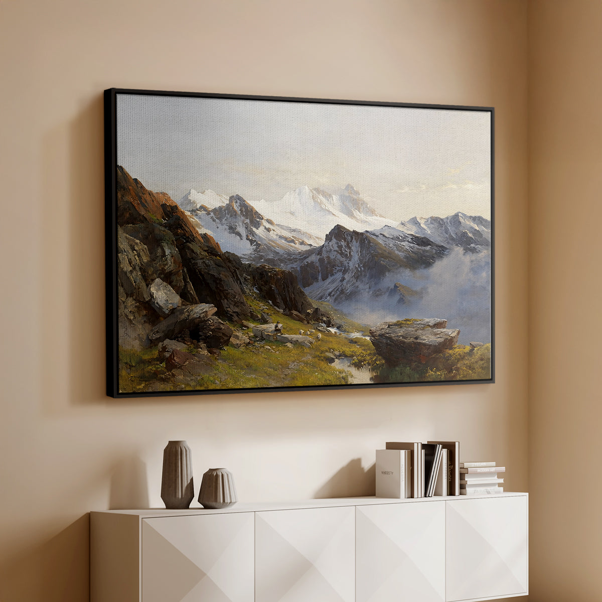 Black floater framed canvas of The Großglockner from the Prager Hut, 1890 by Edward Theodore Compton, featuring a mountain summit seen from elevated viewpoint with surrounding landscape above a console cabinet in a minimalist entryway.