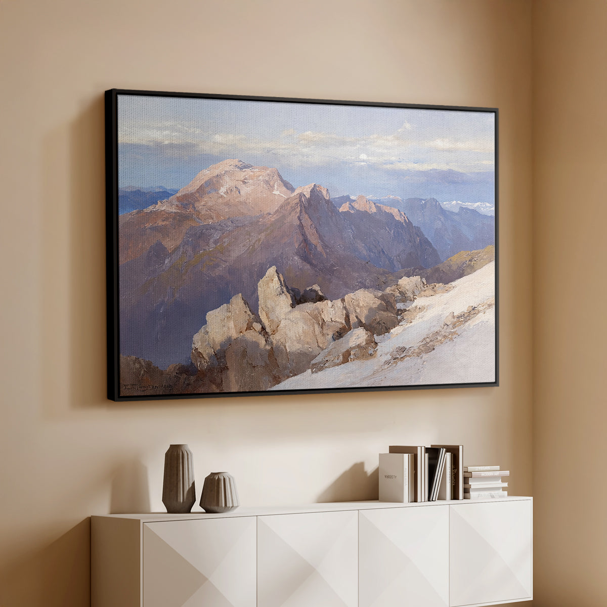 Black floater framed canvas of Hoher Göll from Watzmann-Hocheck, 1919 by Edward Theodore Compton, featuring an alpine panorama showing layered peaks and valleys above a console cabinet in a minimalist entryway.