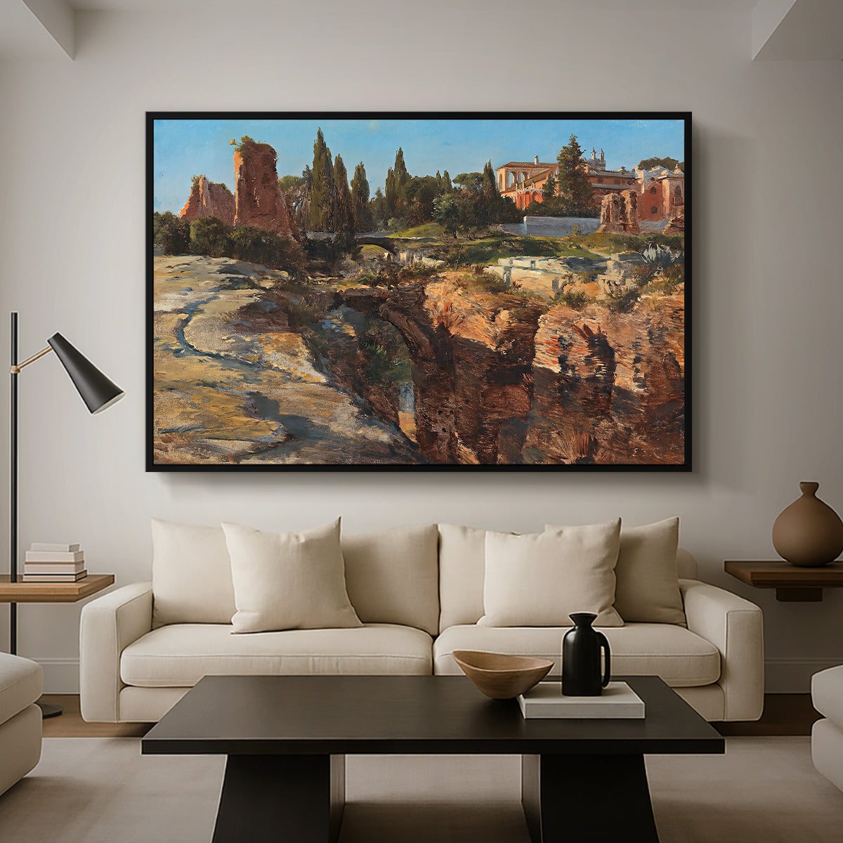 Palatine in Rome, c. 1921 by Edward Theodore Compton as a black floater framed canvas featuring historic Roman ruins and buildings set within warm landscape, displayed above a sofa in a modern living room.