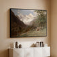 Black floater framed canvas of Landscape in the Caucasus, c. 1921 by Edward Theodore Compton, featuring an expansive view of Caucasus mountains under open sky above a console cabinet in a minimalist entryway.