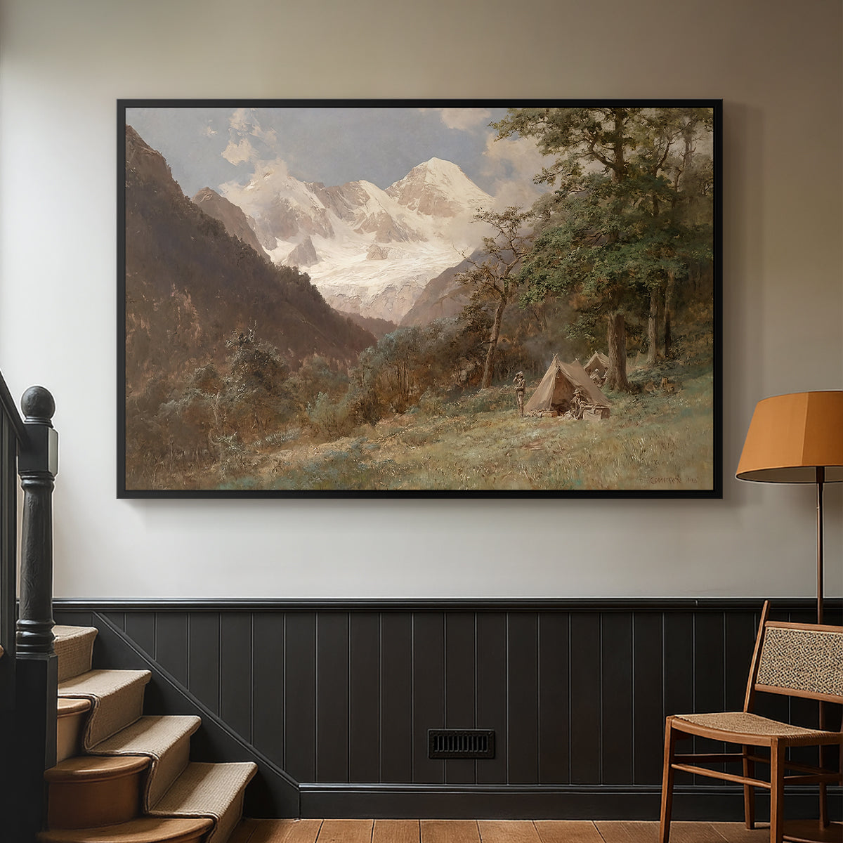 Black floater framed canvas featuring a realistic depiction of remote mountain environment, displayed in a hallway near a staircase.