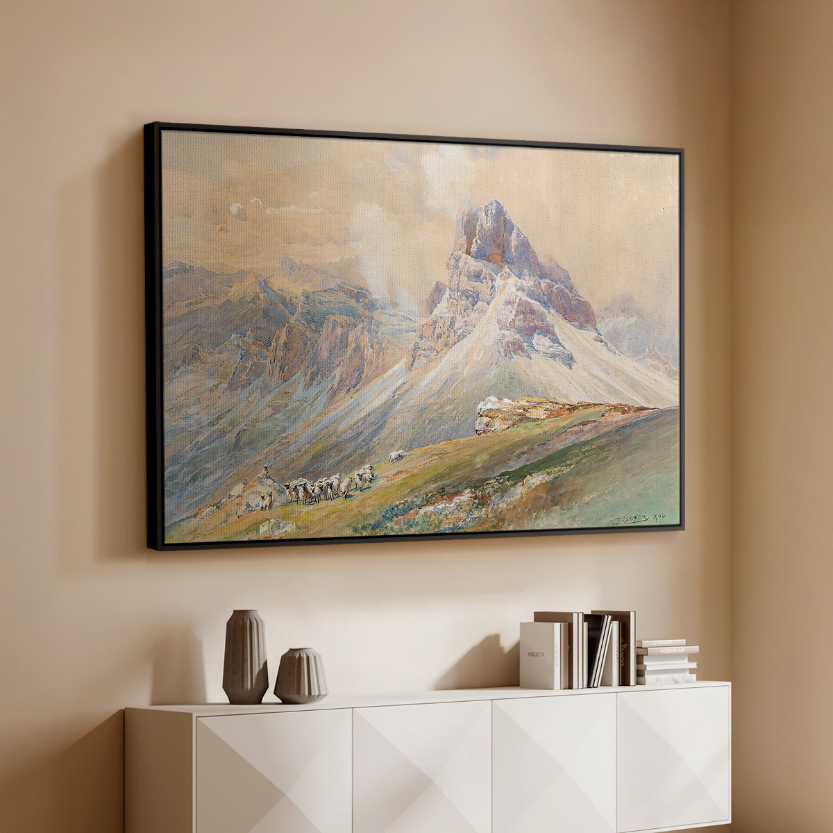 Black floater framed canvas of From the Dolomites, 1904 by Edward Theodore Compton, featuring an alpine scene with jagged rock formations and distant mountains above a console cabinet in a minimalist entryway.