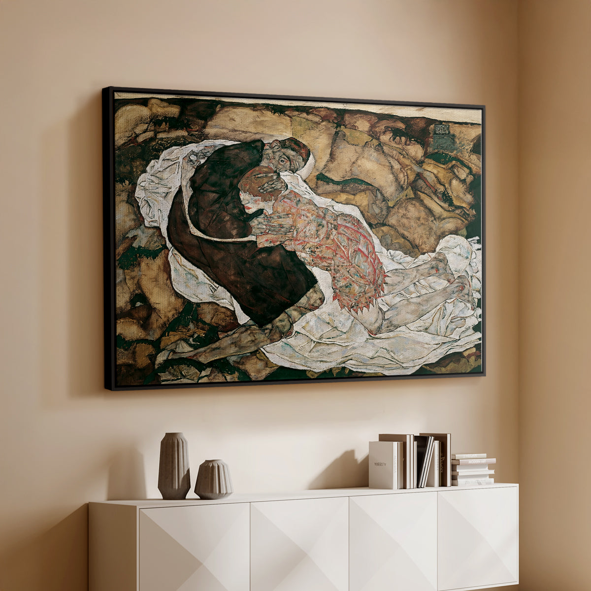 Black floater framed canvas of Death and the Maiden, 1915 by Egon Schiele, featuring a symbolic scene of mortality with two figures clinging together above a console cabinet in a minimalist entryway.