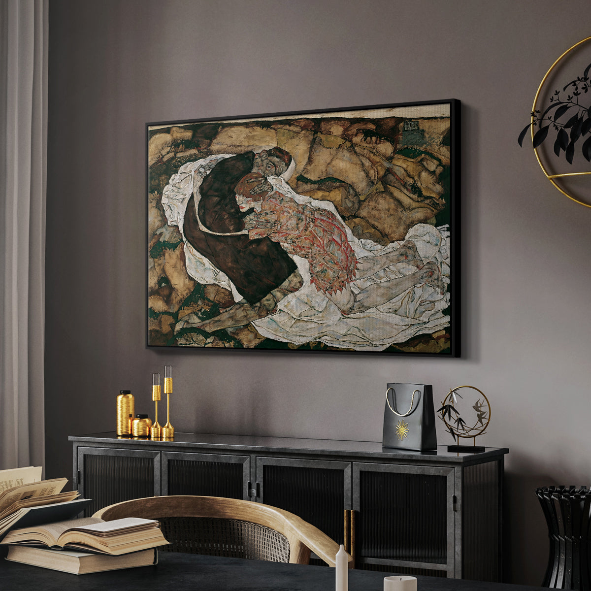 Death and the Maiden, 1915 by Egon Schiele in a black floater framed canvas featuring an expressionist painting of human figures in dramatic pose, displayed above a desk in a dark home office interior.