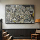 Black floater framed canvas featuring a stylized urban composition with geometric structures and muted tones, displayed in a hallway near a staircase.