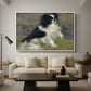 Tama, the Japanese Dog, c. 1876 by Pierre-Auguste Renoir as a white floater framed canvas featuring a small black and white dog standing in shallow water with soft brushstrokes, displayed above a sofa in a modern living room.