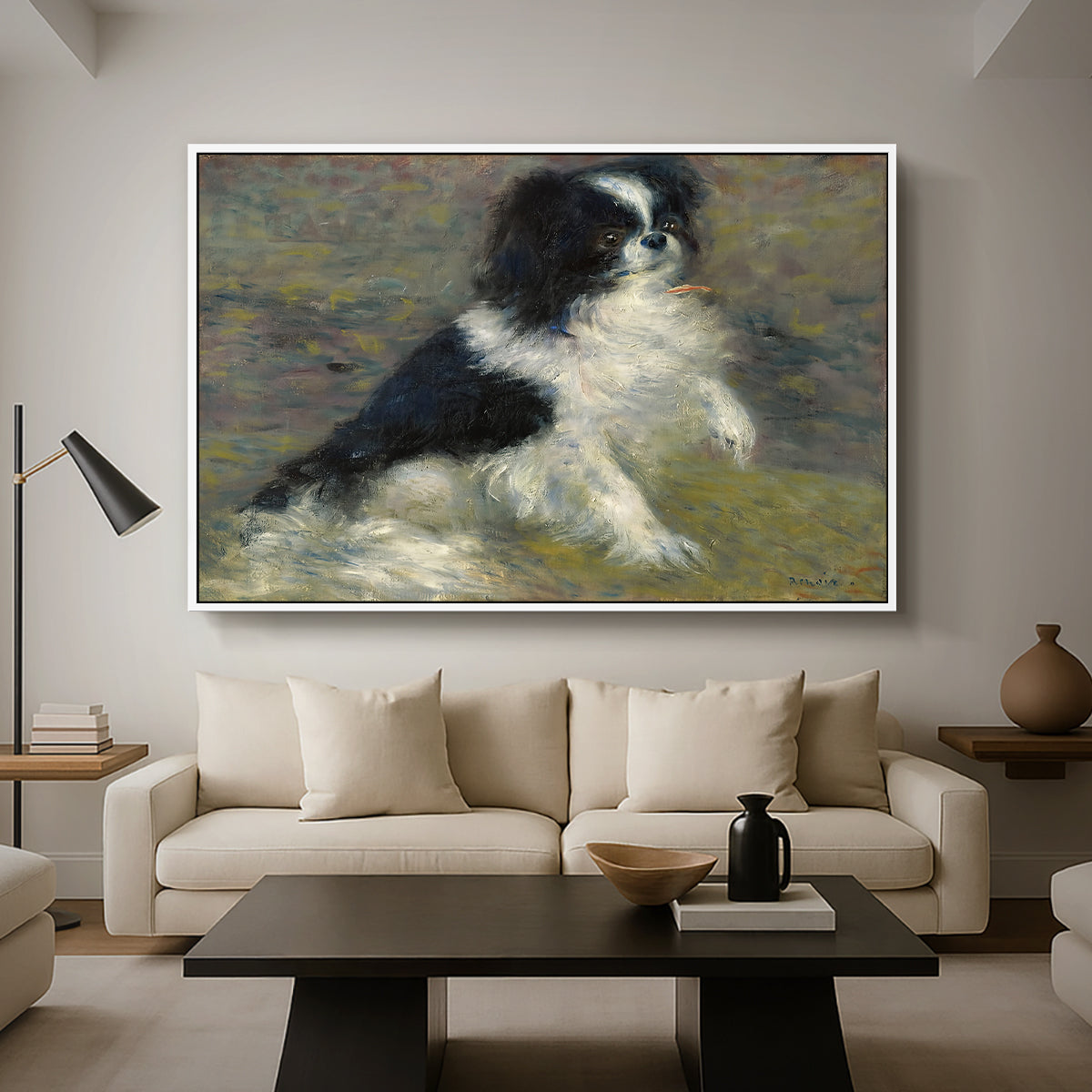 Tama, the Japanese Dog, c. 1876 by Pierre-Auguste Renoir as a white floater framed canvas featuring a small black and white dog standing in shallow water with soft brushstrokes, displayed above a sofa in a modern living room.