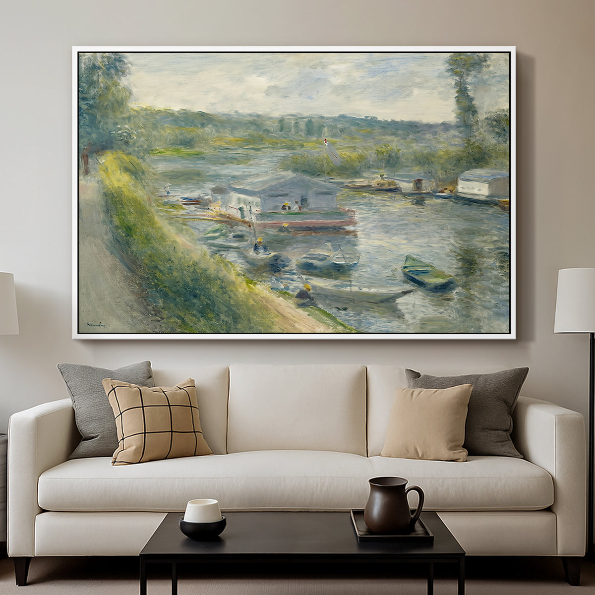 Wash-House Boat at Bas-Meudon, c. 1874 by Pierre-Auguste Renoir displayed in a white floater framed canvas above a sofa in a clean living room.