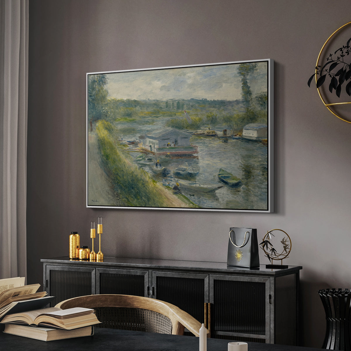 Wash-House Boat at Bas-Meudon, c. 1874 by Pierre-Auguste Renoir in a white floater framed canvas featuring an impressionist depiction of working boat along calm waterway, displayed above a desk in a dark home office interior.