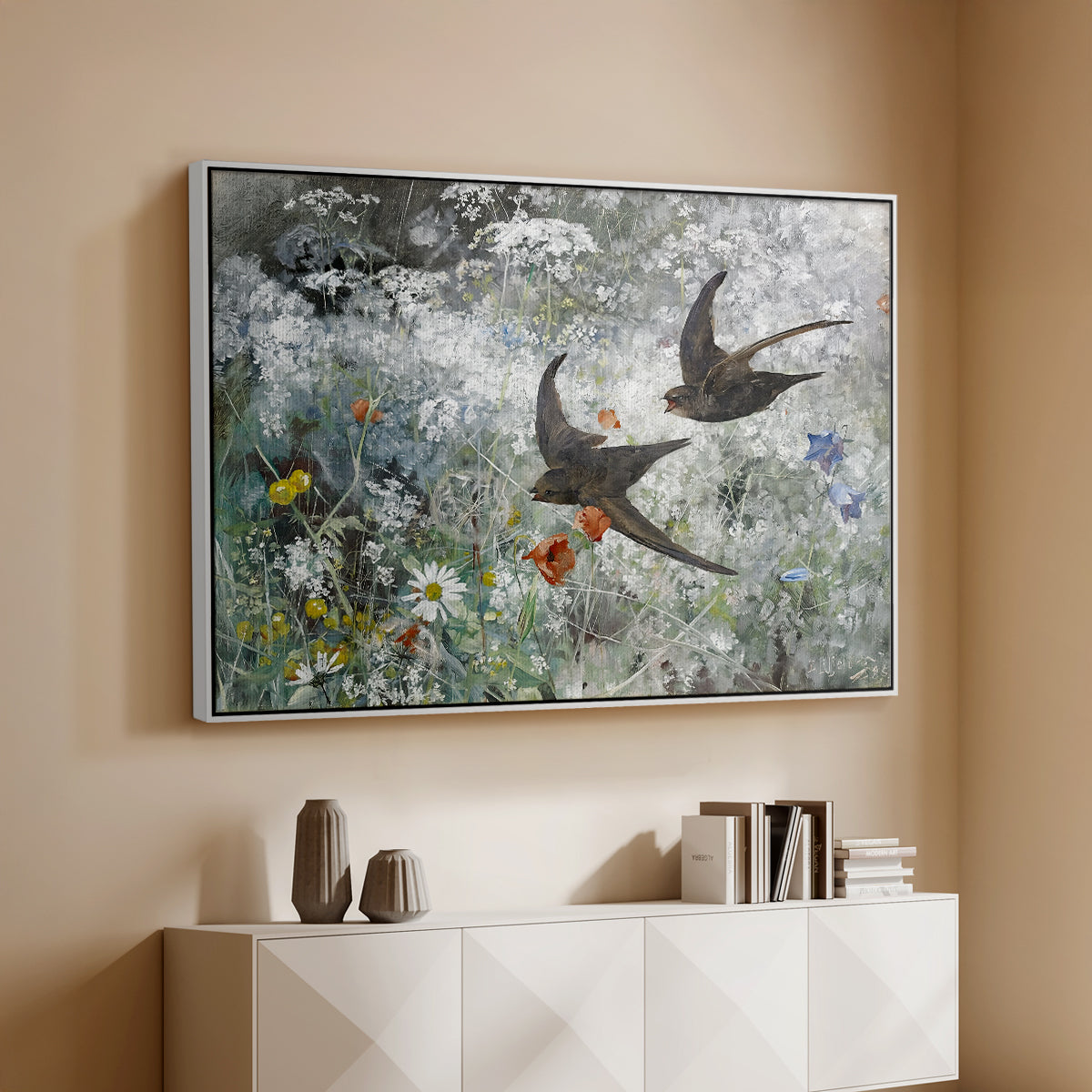 White floater framed canvas of Common Swifts, 1886 by Bruno Liljefors, featuring swifts gliding midair with wings spread against soft sky above a console cabinet in a minimalist entryway.