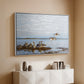 White floater framed canvas of Greylag Geese (Grågäss), 1922 by Bruno Liljefors, featuring birds standing and resting along shoreline with soft grass and water above a console cabinet in a minimalist entryway.