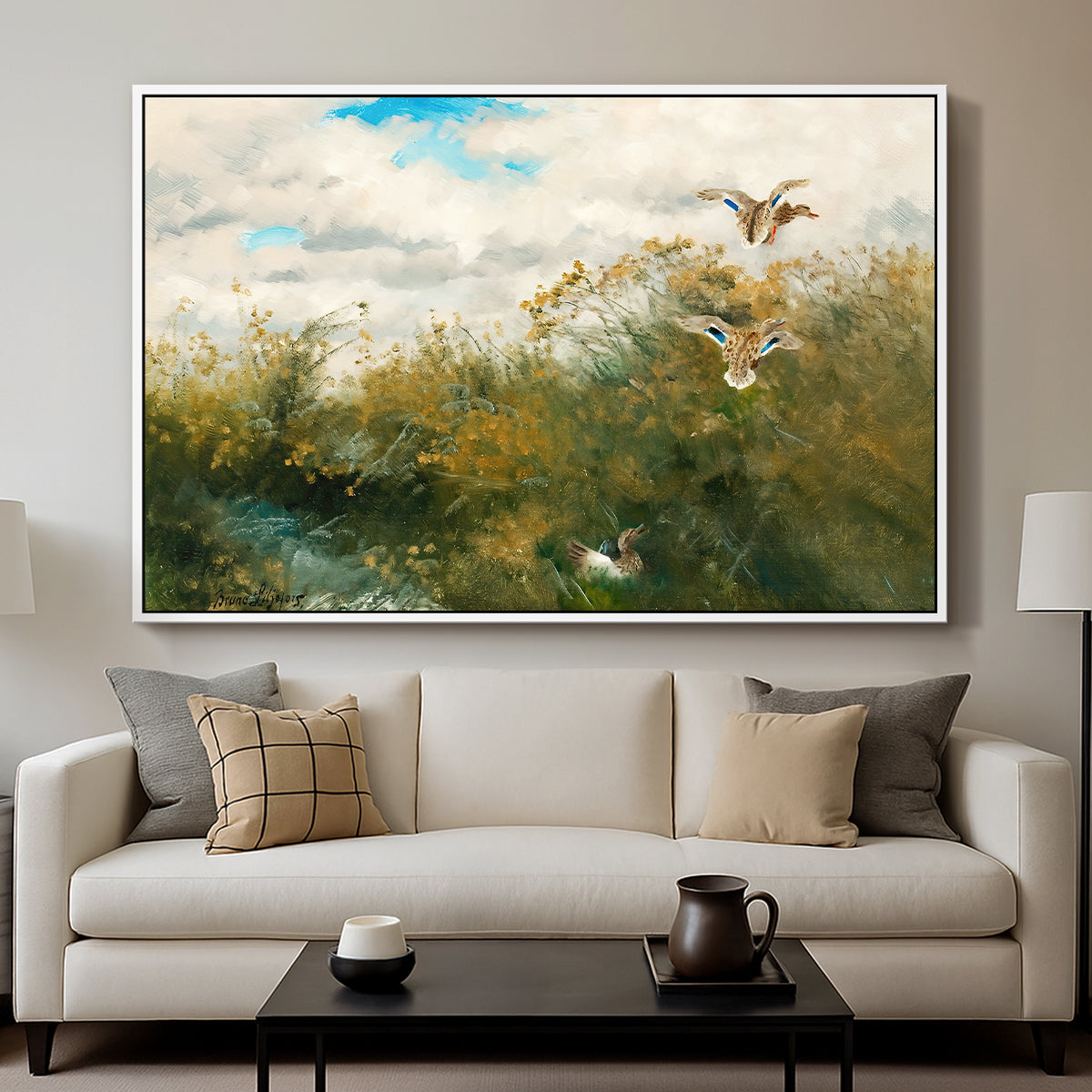 Wild Ducks (Grasänder), 1890 by Bruno Liljefors displayed in a white floater framed canvas above a sofa in a clean living room.