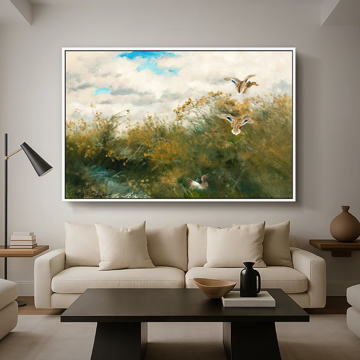 Wild Ducks (Grasänder), 1890 by Bruno Liljefors as a white floater framed canvas featuring ducks moving through grassy wetland near water's edge, displayed above a sofa in a modern living room.