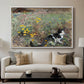 Cat on a Flowery Meadow, 1887 by Bruno Liljefors displayed in a white floater framed canvas above a sofa in a clean living room.