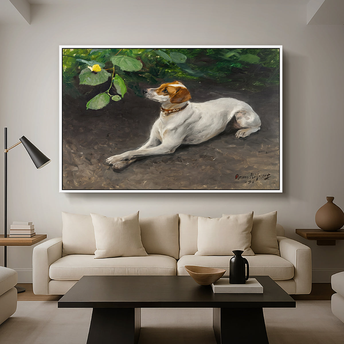 Portrait of a Dog, 1891 by Bruno Liljefors as a white floater framed canvas featuring a dog lying on ground with head raised in natural outdoor setting, displayed above a sofa in a modern living room.