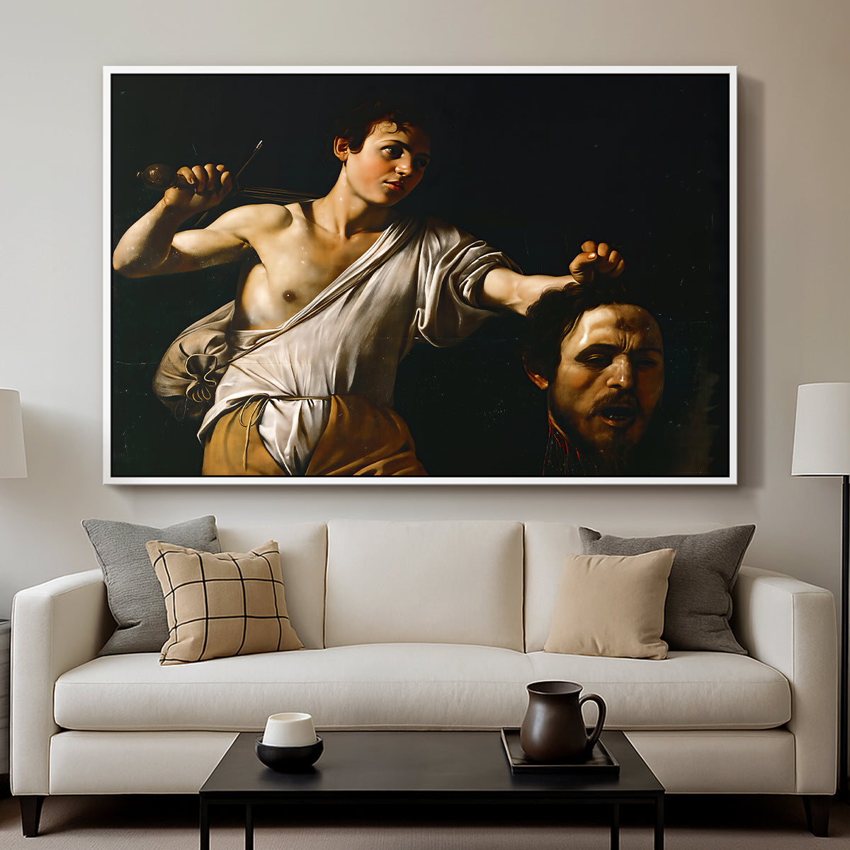 David with the Head of Goliath (Vienna Version), c. 1607 by Caravaggio displayed in a white floater framed canvas above a sofa in a clean living room.