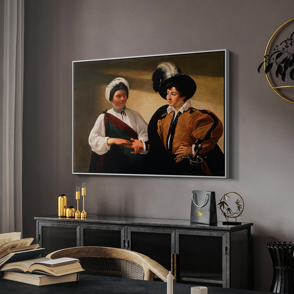 The Fortune Teller (Louvre Version), c. 1595 by Caravaggio in a white floater framed canvas featuring an intimate scene of palm reading with subtle act of theft, displayed above a desk in a dark home office interior.