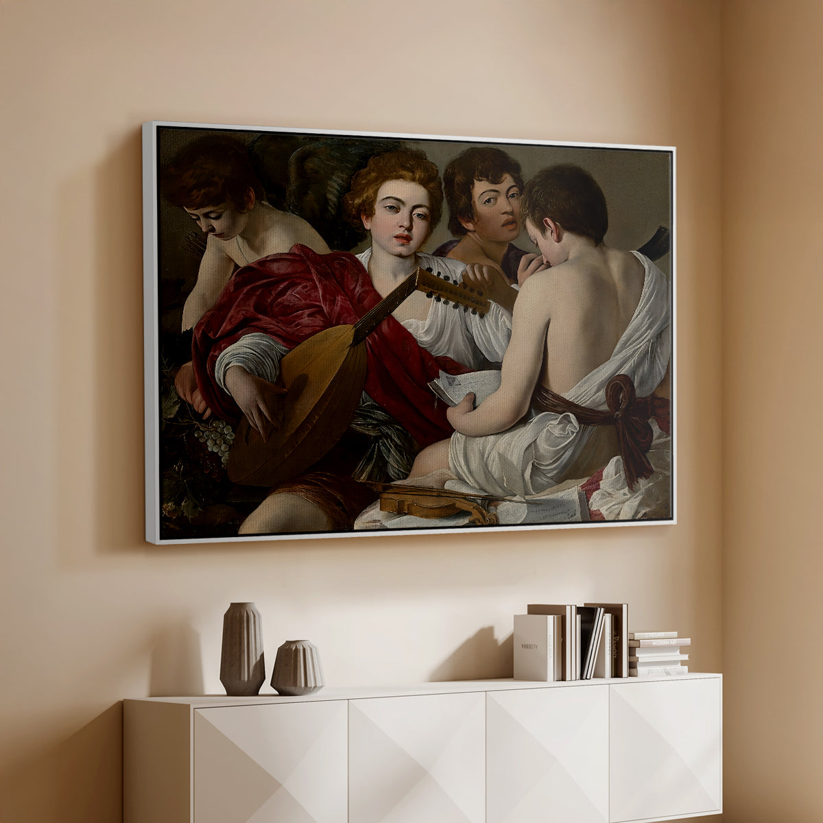 White floater framed canvas of The Musicians, c. 1595 by Caravaggio, featuring an ensemble of musicians holding lute and singing in close arrangement above a console cabinet in a minimalist entryway.