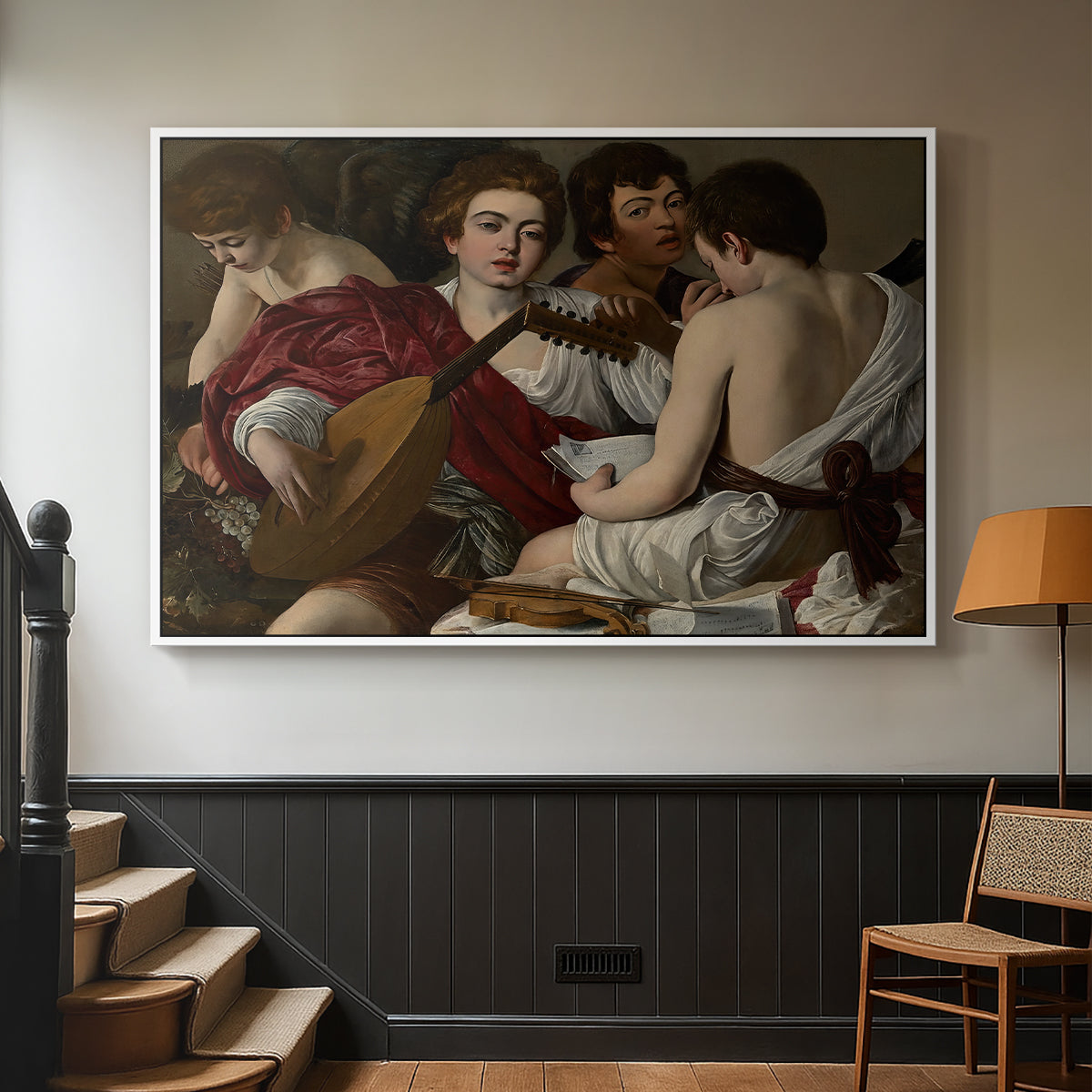 White floater framed canvas featuring a musical gathering with figures posed closely in soft light, displayed in a hallway near a staircase.