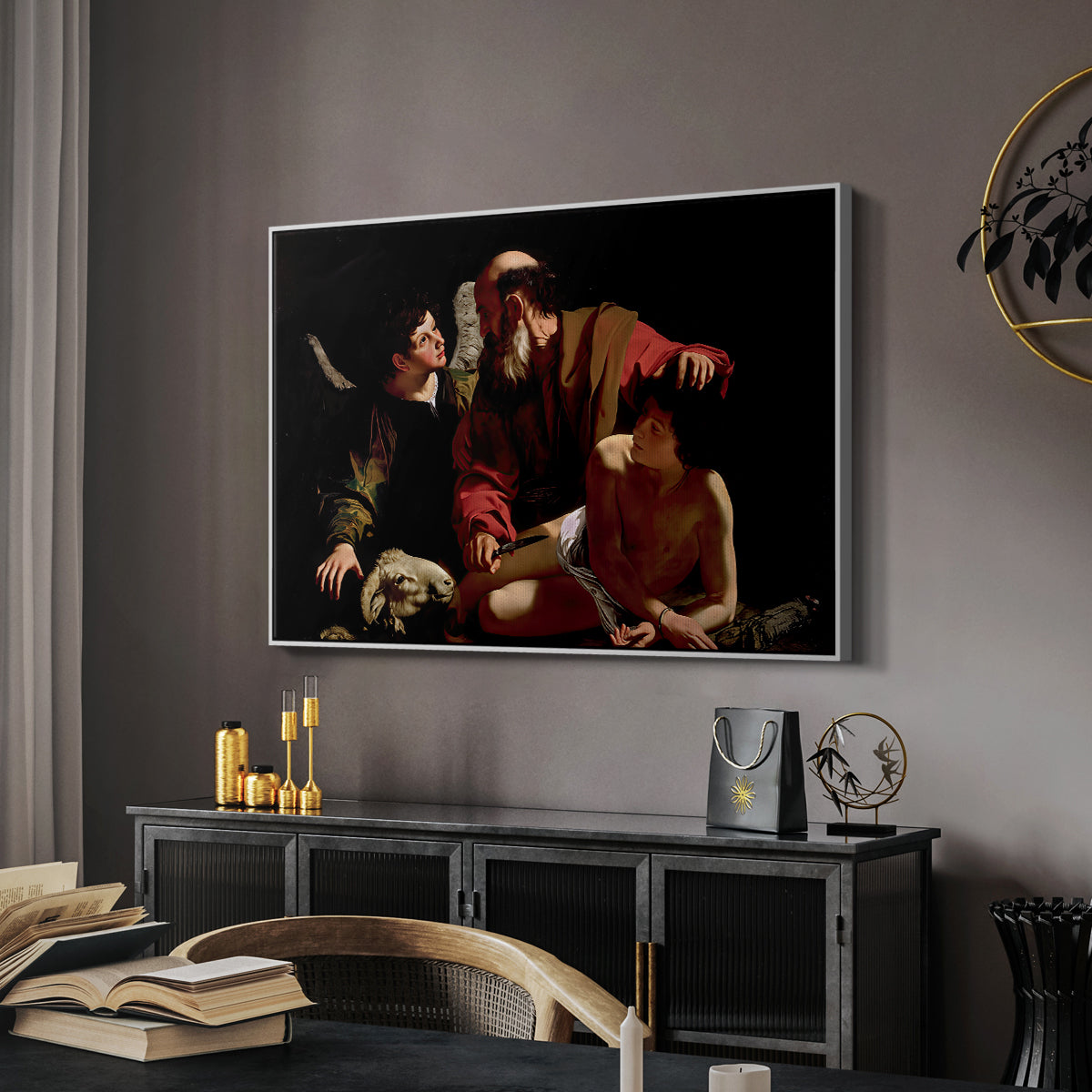 The Sacrifice of Isaac (Uffizi Version), c. 1603 by Caravaggio in a white floater framed canvas featuring a dramatic moment of divine intervention during sacrifice of Isaac, displayed above a desk in a dark home office interior.