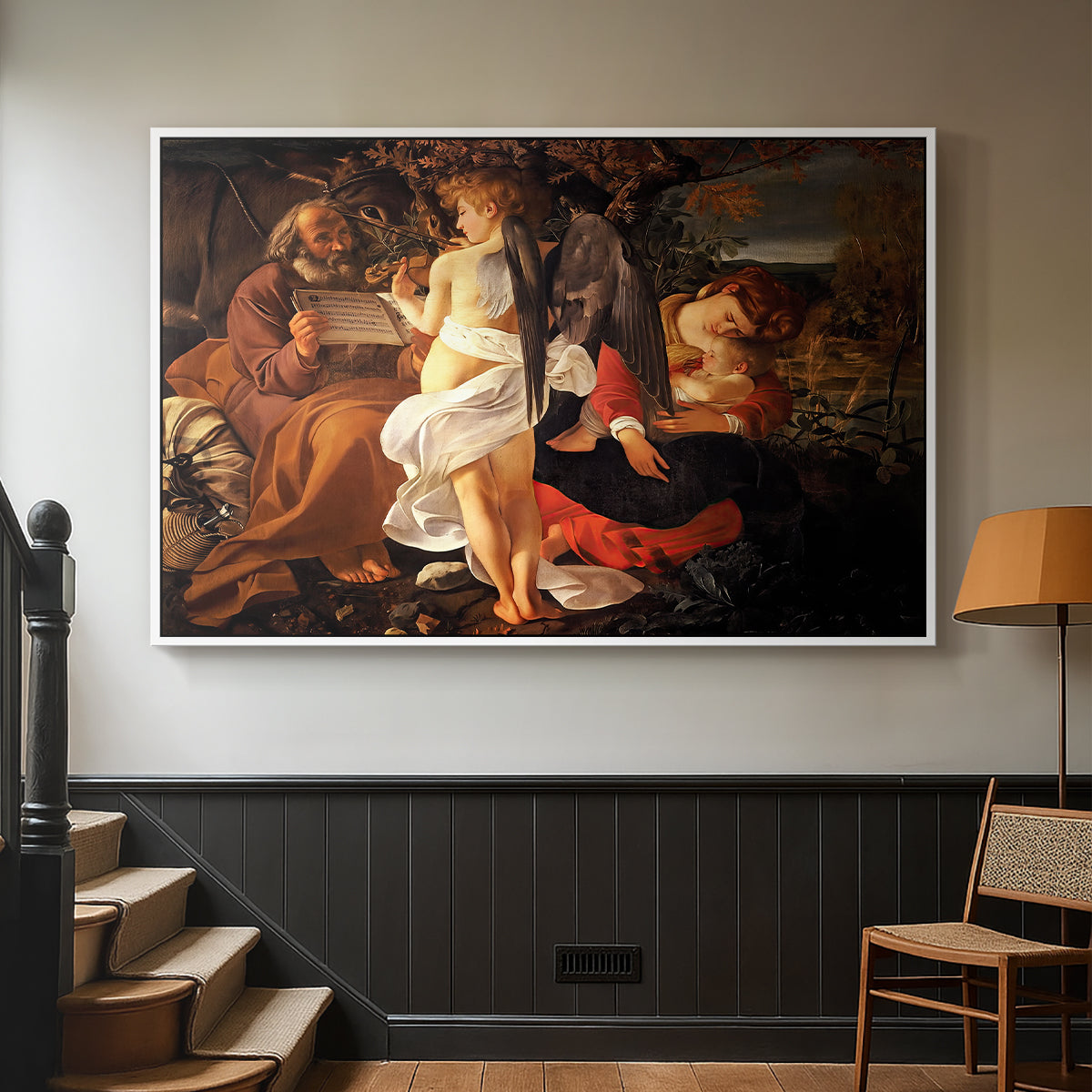 White floater framed canvas featuring a Baroque landscape with angel playing music for resting travelers, displayed in a hallway near a staircase.