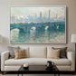 Waterloo Bridge, Gray Weather, 1900 by Claude Monet displayed in a white floater framed canvas above a sofa in a clean living room.