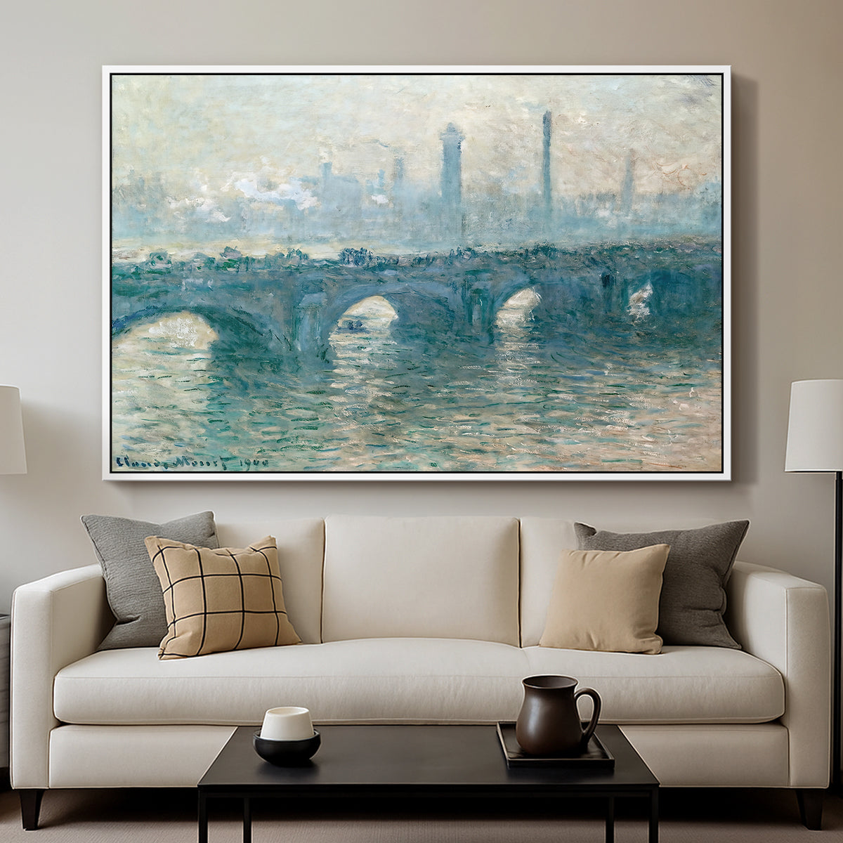 Waterloo Bridge, Gray Weather, 1900 by Claude Monet displayed in a white floater framed canvas above a sofa in a clean living room.