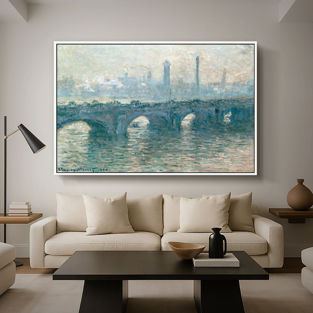 Waterloo Bridge, Gray Weather, 1900 by Claude Monet as a white floater framed canvas featuring a hazy view of Waterloo Bridge over river in gray atmospheric light, displayed above a sofa in a modern living room.