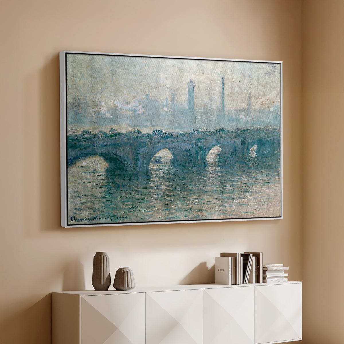 White floater framed canvas of Waterloo Bridge, Gray Weather, 1900 by Claude Monet, featuring an impressionist cityscape with bridge fading into fog over water above a console cabinet in a minimalist entryway.