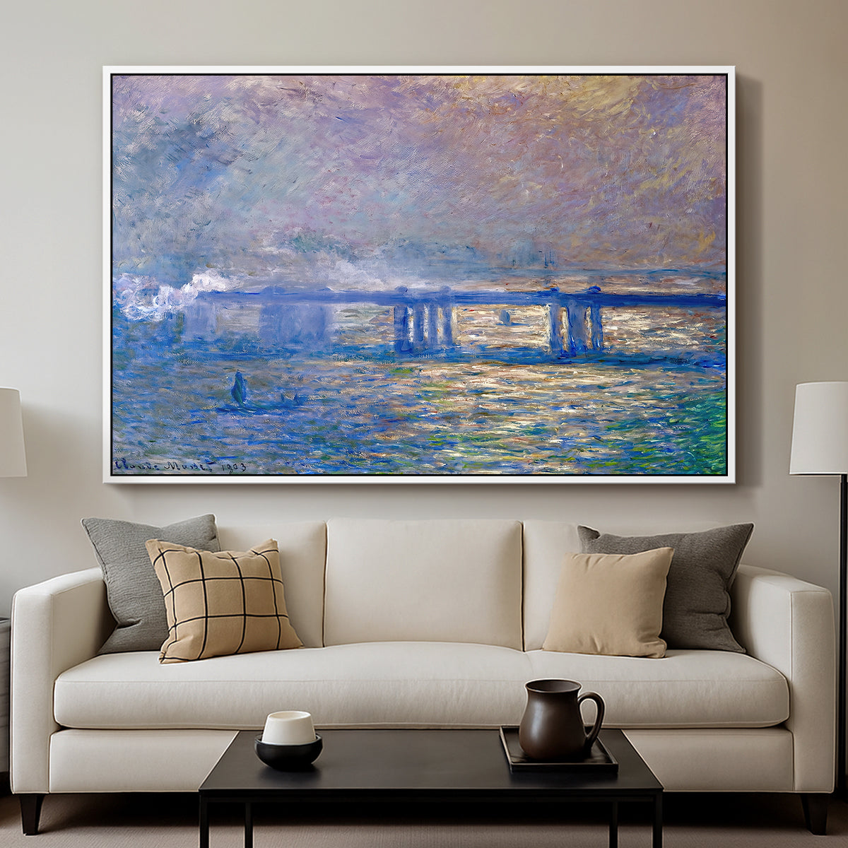 Charing Cross Bridge, 1903 by Claude Monet displayed in a white floater framed canvas above a sofa in a clean living room.