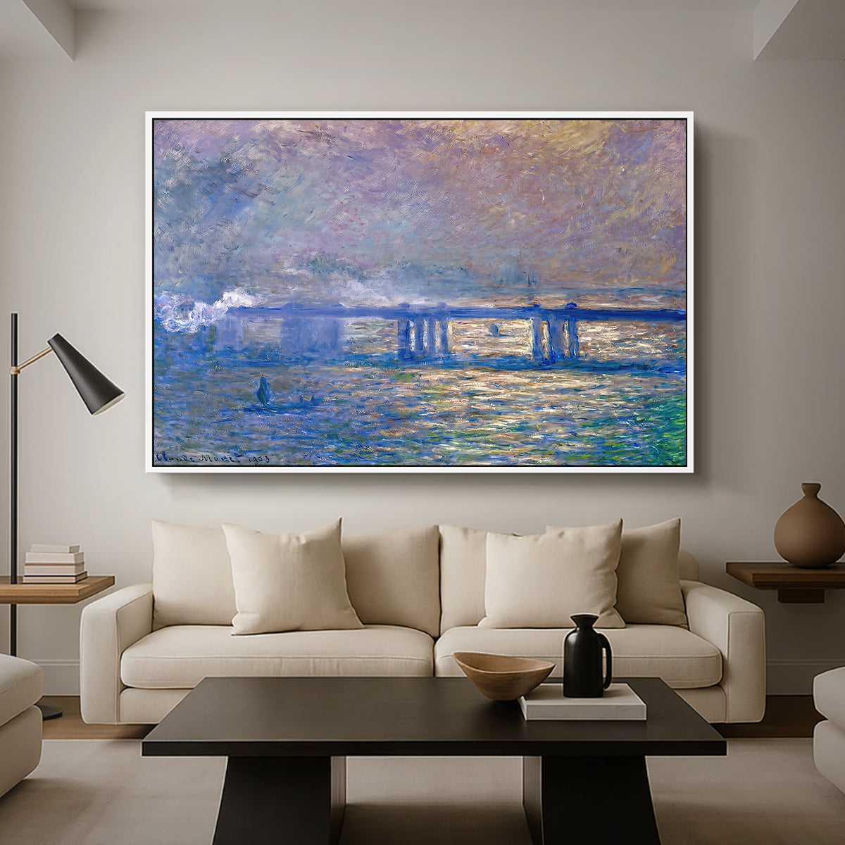 Charing Cross Bridge, 1903 by Claude Monet as a white floater framed canvas featuring an impressionist view of bridge stretching across river with soft light and haze, displayed above a sofa in a modern living room.
