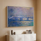 White floater framed canvas of Charing Cross Bridge, 1903 by Claude Monet, featuring an urban landscape with bridge and water rendered in blurred tones above a console cabinet in a minimalist entryway.