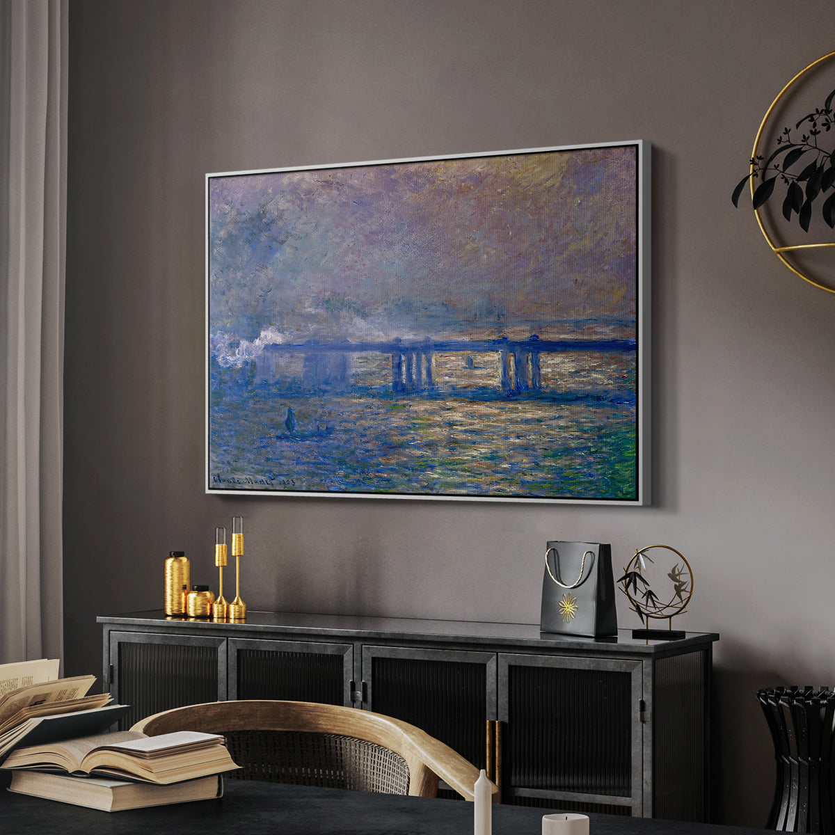 Charing Cross Bridge, 1903 by Claude Monet in a white floater framed canvas featuring an atmospheric depiction of London bridge with reflections in water, displayed above a desk in a dark home office interior.