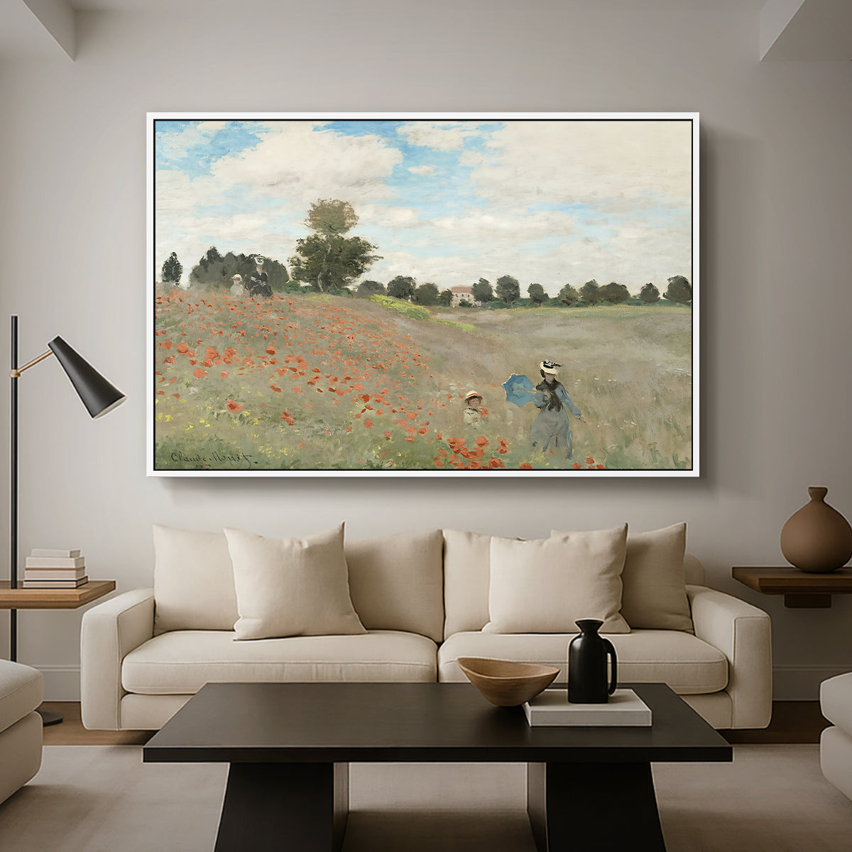 The Poppy Field near Argenteuil, 1873 by Claude Monet as a white floater framed canvas featuring a field of red poppies with figures walking across rolling landscape, displayed above a sofa in a modern living room.