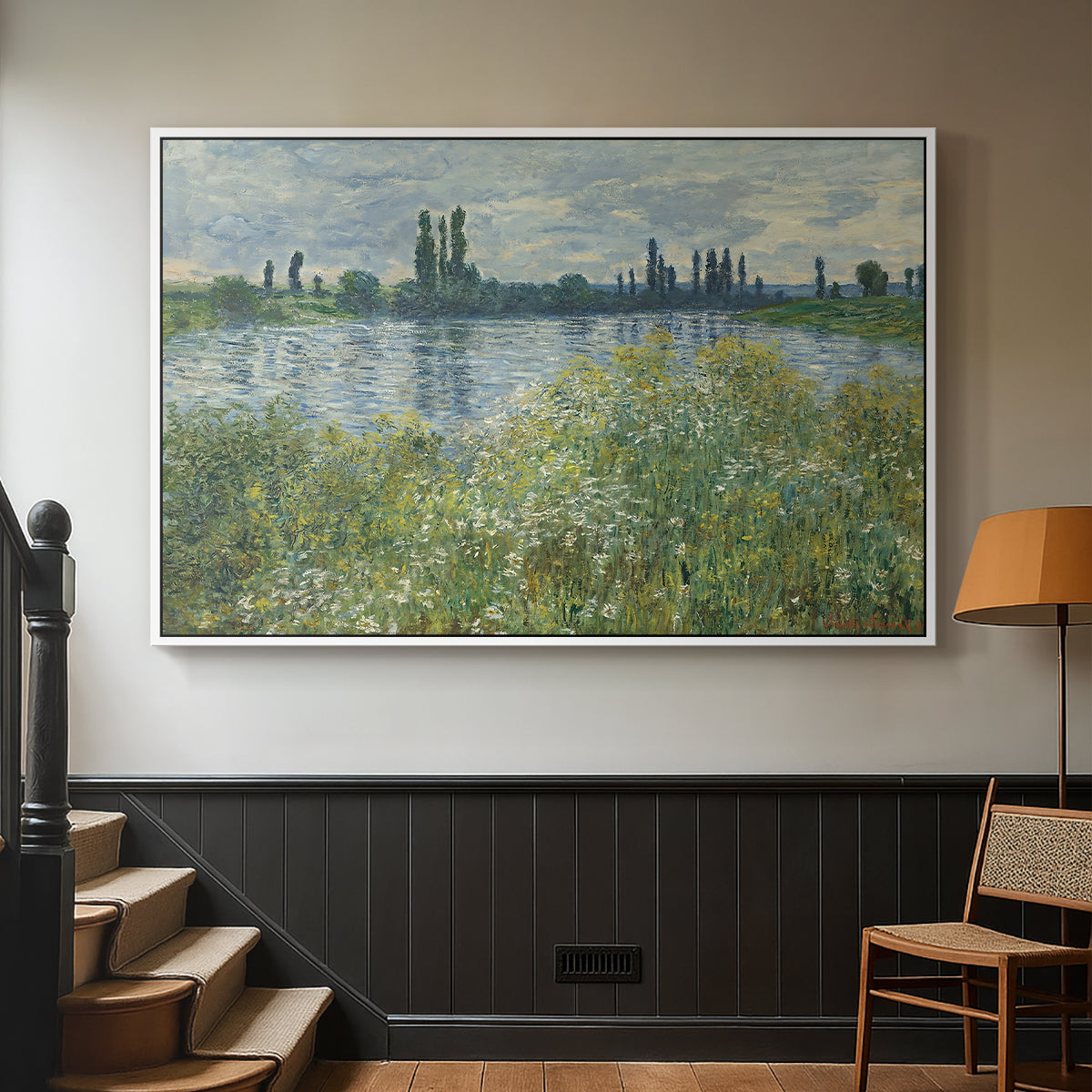 White floater framed canvas featuring a natural landscape with calm water and soft foliage, displayed in a hallway near a staircase.