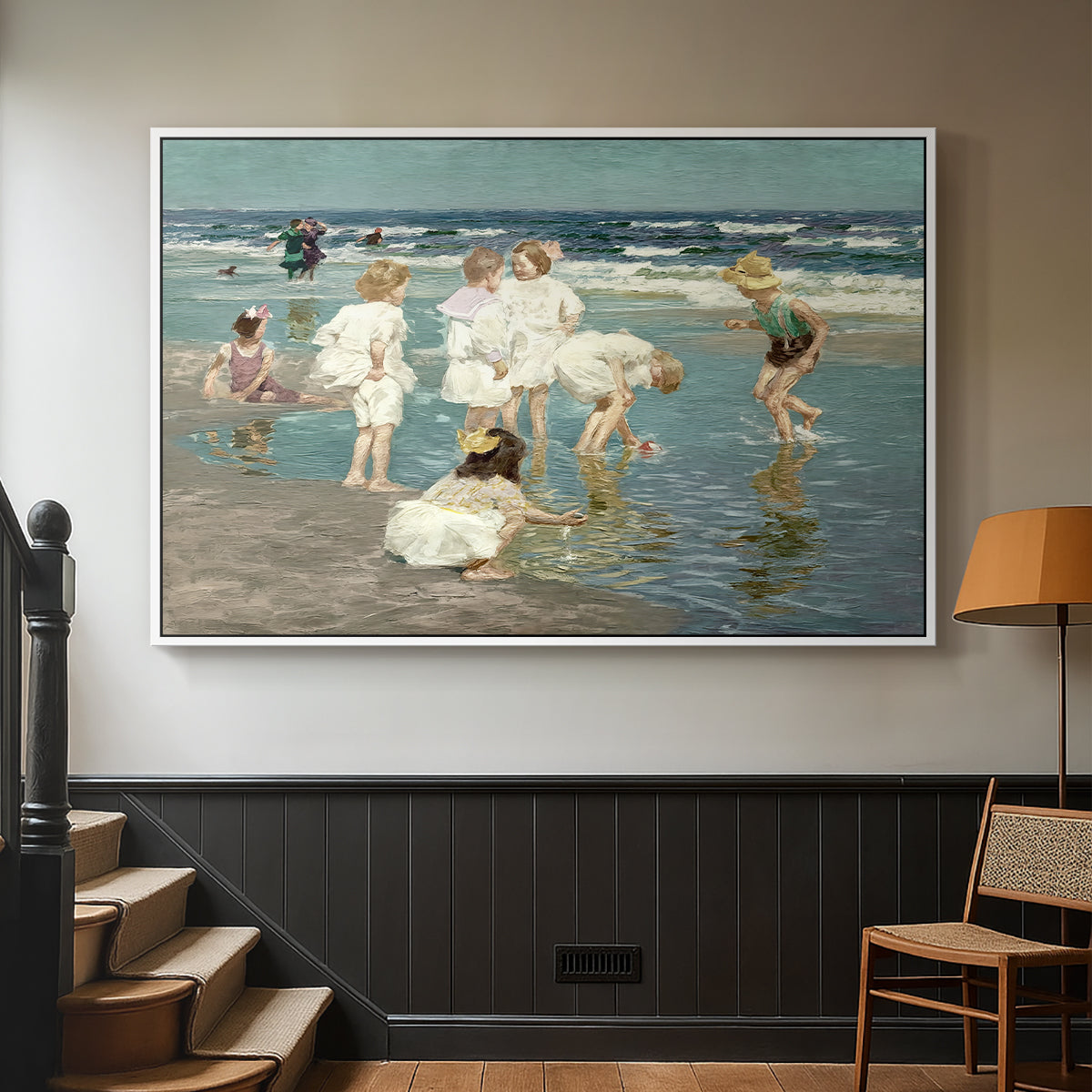 White floater framed canvas featuring a lively shoreline scene with people gathered in surf, displayed in a hallway near a staircase.