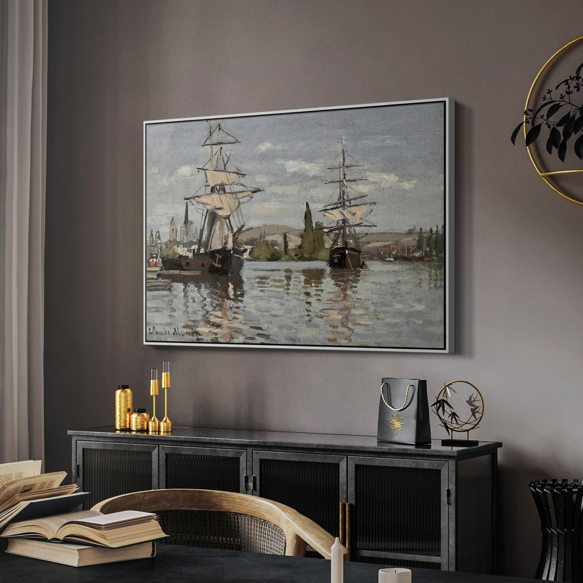 Ships Riding on the Seine at Rouen, 1872 by Claude Monet in a white floater framed canvas featuring a harbor view with tall ships lining the waterfront in muted tones, displayed above a desk in a dark home office interior.