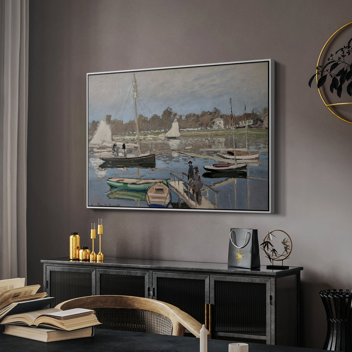 The Basin at Argenteuil, 1874 by Claude Monet in a white floater framed canvas featuring a harbor basin filled with boats under soft sky, displayed above a desk in a dark home office interior.