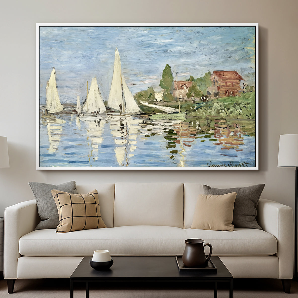 Regatta at Argenteuil, 1872 by Claude Monet displayed in a white floater framed canvas above a sofa in a clean living room.