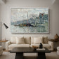View of the Prins Hendrikkade and Kromme Waal in Amsterdam, 1874 by Claude Monet as a white floater framed canvas featuring a canal scene with boats and buildings lining waterfront in Amsterdam, displayed above a sofa in a modern living room.