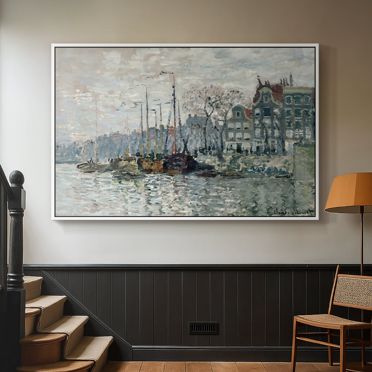 White floater framed canvas featuring a harbor view with masts, houses, and reflections in water, displayed in a hallway near a staircase.