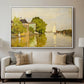 Houses on the Achterzaan, 1871 by Claude Monet displayed in a white floater framed canvas above a sofa in a clean living room.