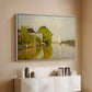 White floater framed canvas of Houses on the Achterzaan, 1871 by Claude Monet, featuring riverside homes with trees and mirrored reflections in water above a console cabinet in a minimalist entryway.