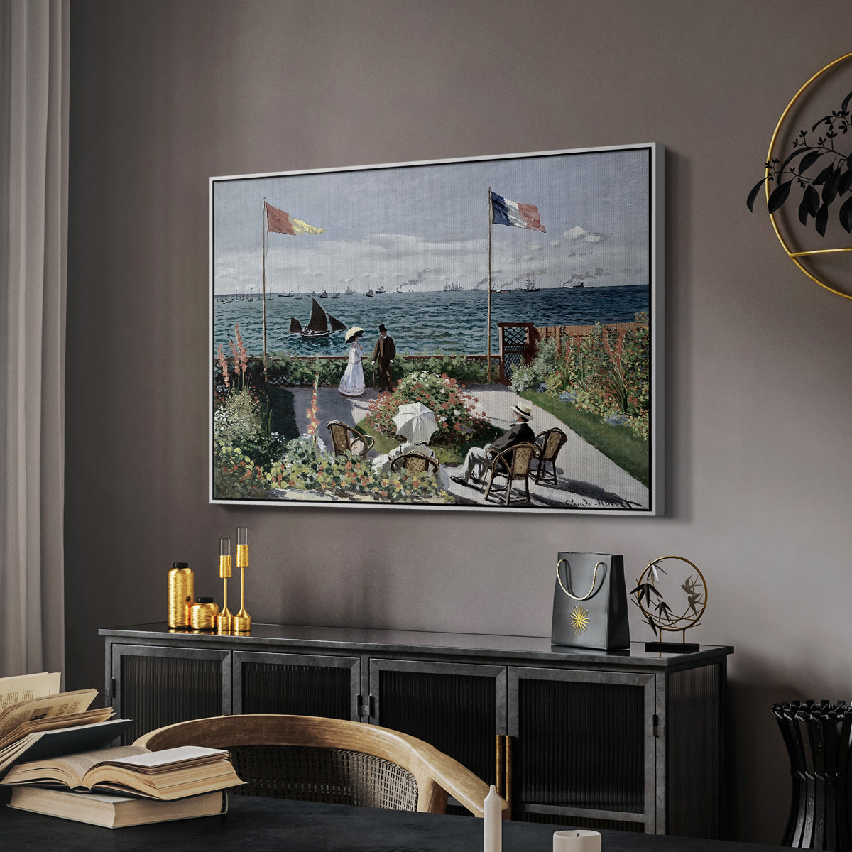 Garden at Sainte-Adresse, 1867 by Claude Monet in a white floater framed canvas featuring a vibrant garden scene with colorful blooms and distant sea, displayed above a desk in a dark home office interior.
