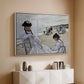 White floater framed canvas of On the Beach at Trouville, 1870 by Claude Monet, featuring an impressionist seaside scene with women in dresses and hats above a console cabinet in a minimalist entryway.