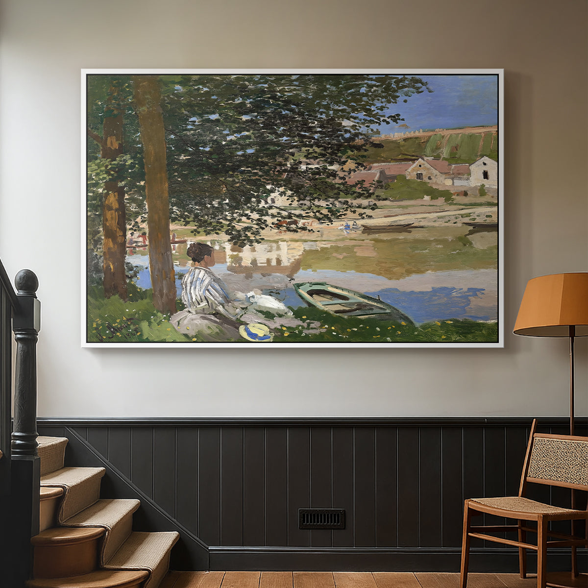 White floater framed canvas featuring a quiet outdoor setting with figures near river under foliage, displayed in a hallway near a staircase.