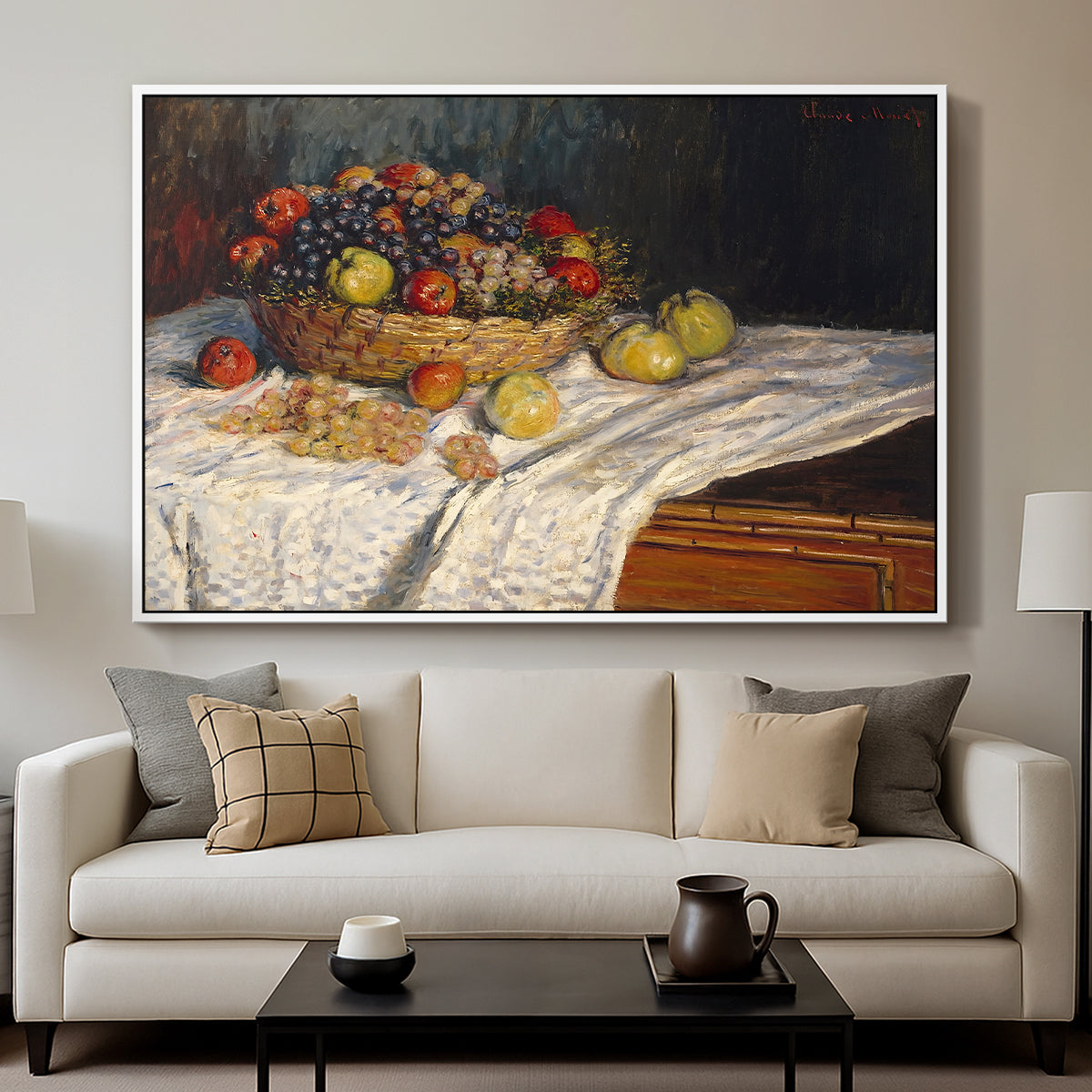 Still Life with Apples and Grapes, 1880 by Claude Monet displayed in a white floater framed canvas above a sofa in a clean living room.