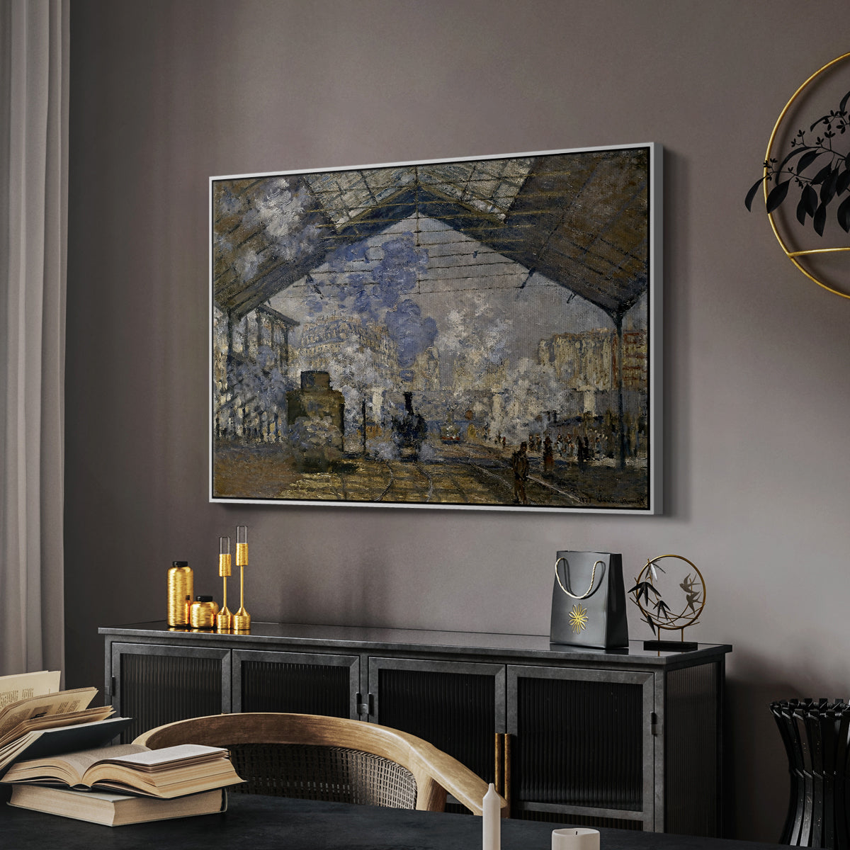 The Gare Saint-Lazare, 1877 by Claude Monet in a white floater framed canvas featuring an industrial interior with steam clouds and rail tracks, displayed above a desk in a dark home office interior.
