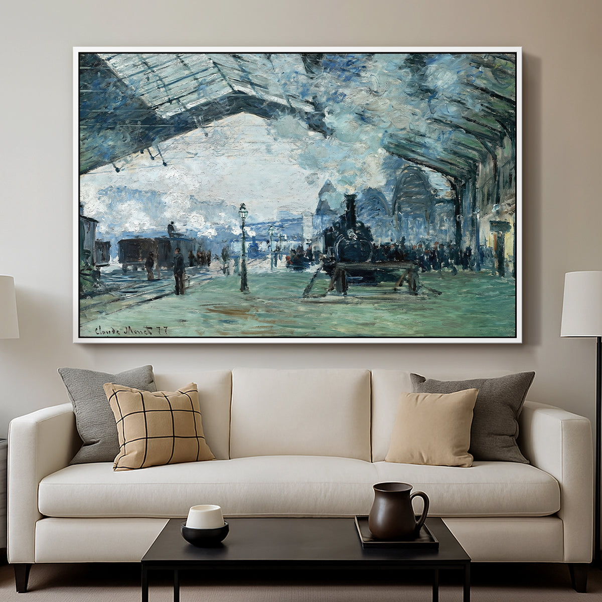 The Saint-Lazare Station, 1877 by Claude Monet displayed in a white floater framed canvas above a sofa in a clean living room.